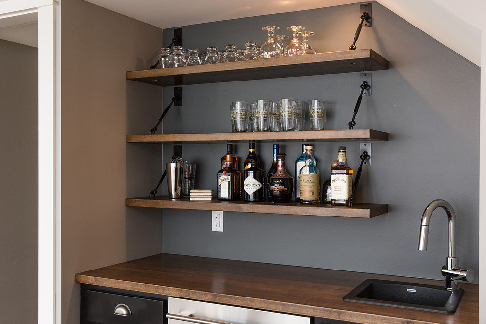 Large arts and crafts single-wall wet bar in Other with a drop-in sink, recessed-panel cabinets, wood benchtops, grey splashback and brown benchtop.