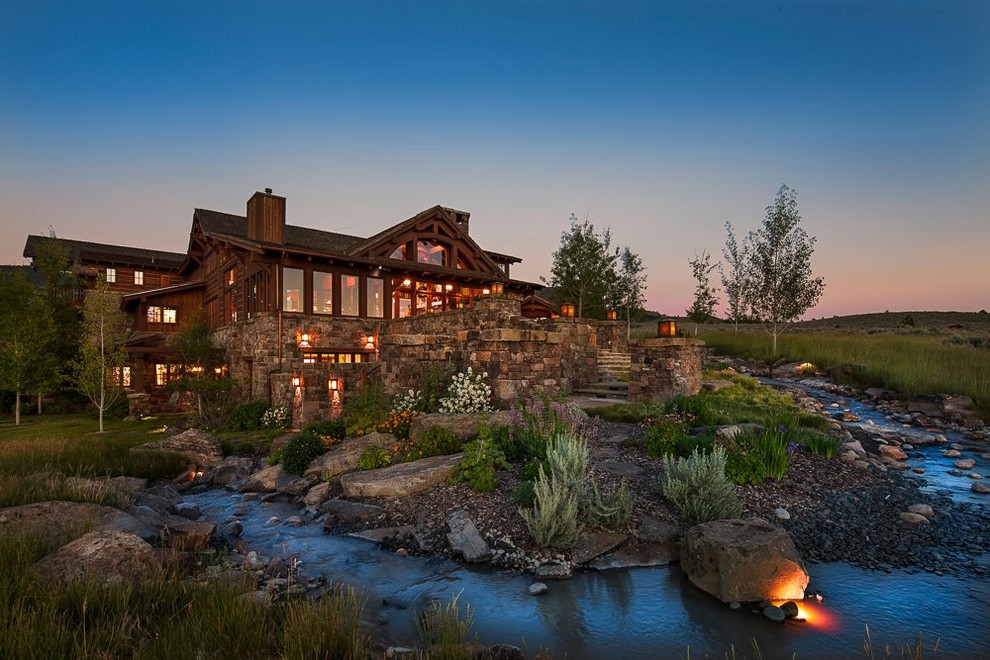 This is an example of a large rustic backyard stone garden path.