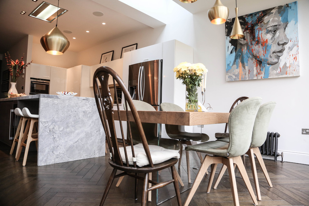 Design ideas for a large contemporary open plan dining in London with white walls and dark hardwood floors.
