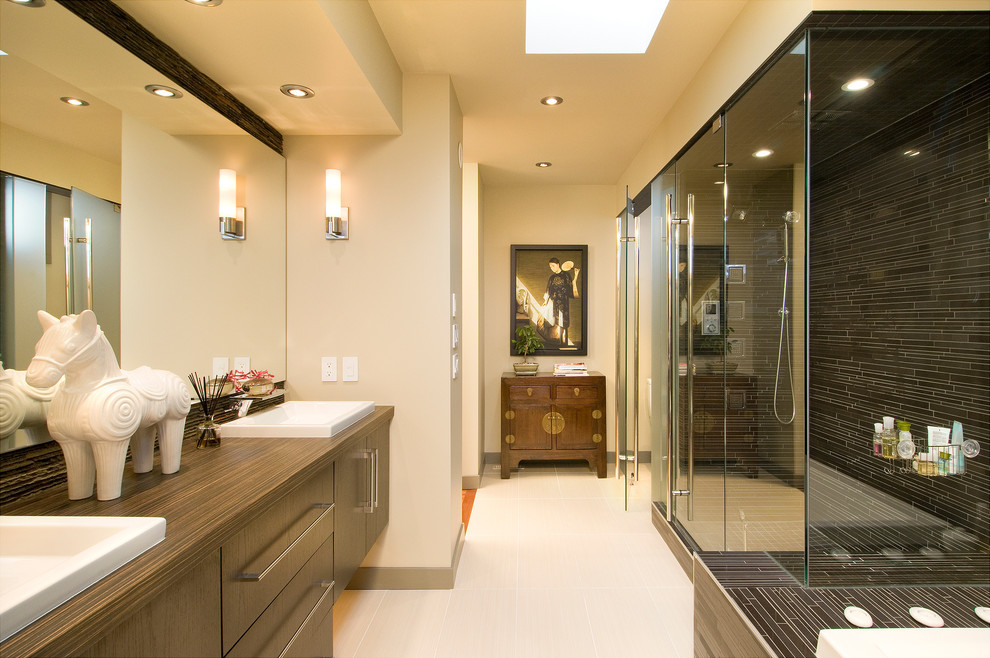 Contemporary bathroom in Calgary with a drop-in sink, flat-panel cabinets, medium wood cabinets, black tile, matchstick tile, wood benchtops and brown benchtops.