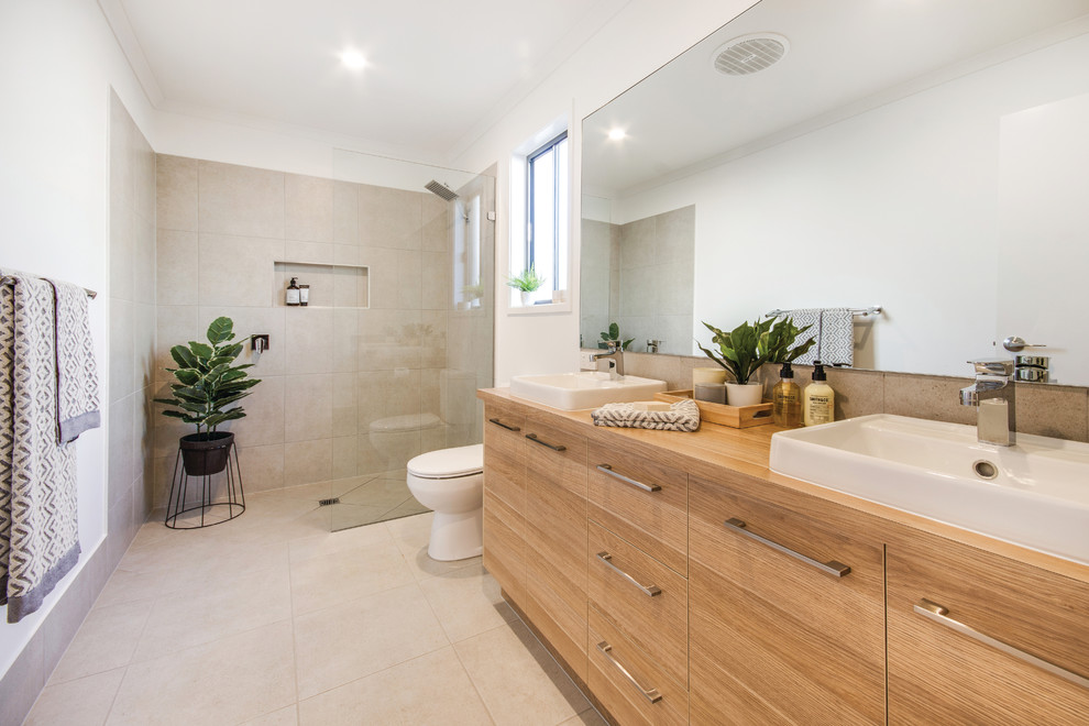 Contemporary master bathroom in Sunshine Coast with an open shower, a one-piece toilet, beige tile, cement tile, white walls, ceramic floors, beige floor, an open shower and a vessel sink.