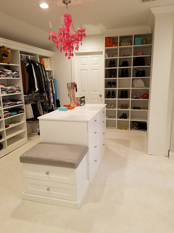 Design ideas for a large classic gender neutral dressing room in New York with open cabinets, white cabinets, carpet and white floors.