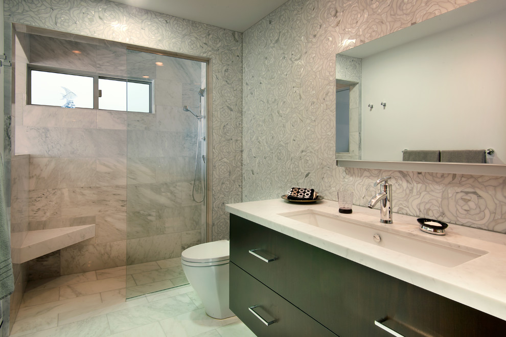 Design ideas for a large contemporary 3/4 bathroom in San Diego with an undermount sink, flat-panel cabinets, dark wood cabinets, a curbless shower, white tile, grey walls, marble floors, marble benchtops, marble, a one-piece toilet, white floor and an open shower.