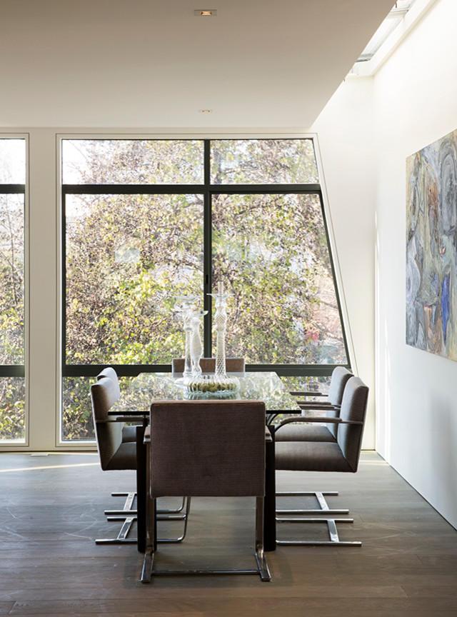 Mid-sized modern dining room in San Francisco with white walls, dark hardwood floors and a ribbon fireplace.