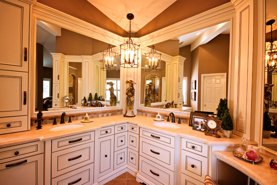This is an example of a mid-sized traditional master bathroom in Sacramento with an undermount sink, beaded inset cabinets, distressed cabinets, limestone benchtops, an open shower, brown tile and limestone floors.