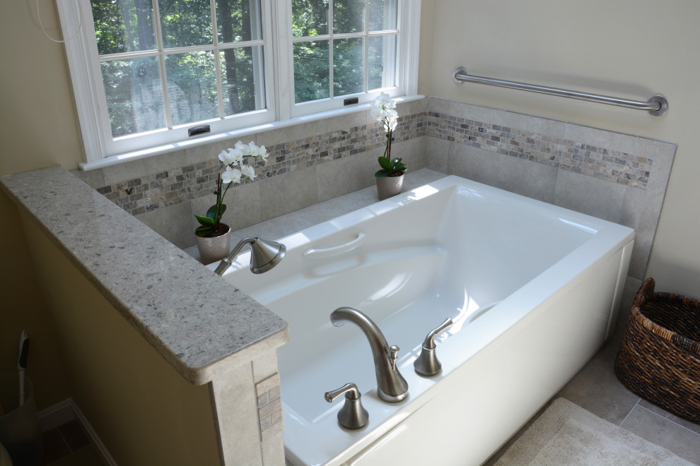 Mid-sized traditional master bathroom in Baltimore with recessed-panel cabinets, beige cabinets, a corner tub, an alcove shower, beige walls, an undermount sink, engineered quartz benchtops, a hinged shower door, grey benchtops, a double vanity and a freestanding vanity.