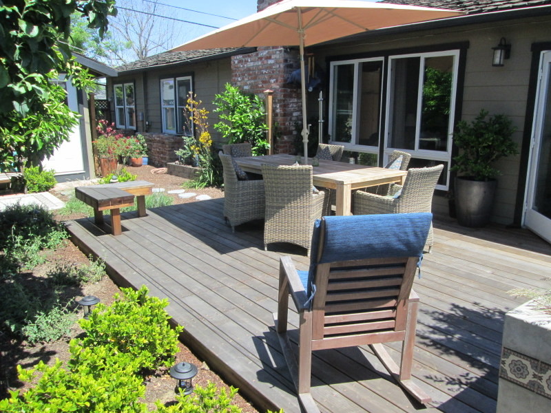 Inspiration for a mid-sized eclectic backyard partial sun garden for summer in San Francisco with decking.