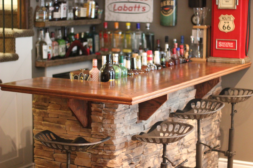Photo of a small arts and crafts l-shaped seated home bar in Other with a drop-in sink and wood benchtops.