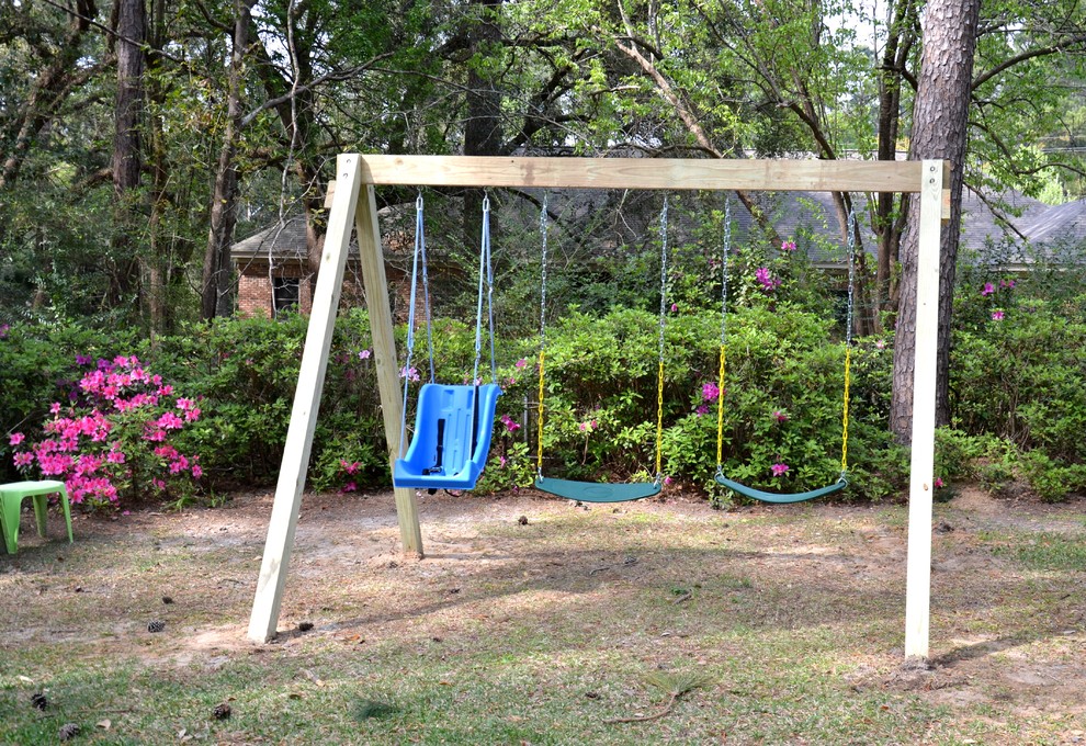 Photo of a mid-sized arts and crafts garden in Atlanta with with outdoor playset.