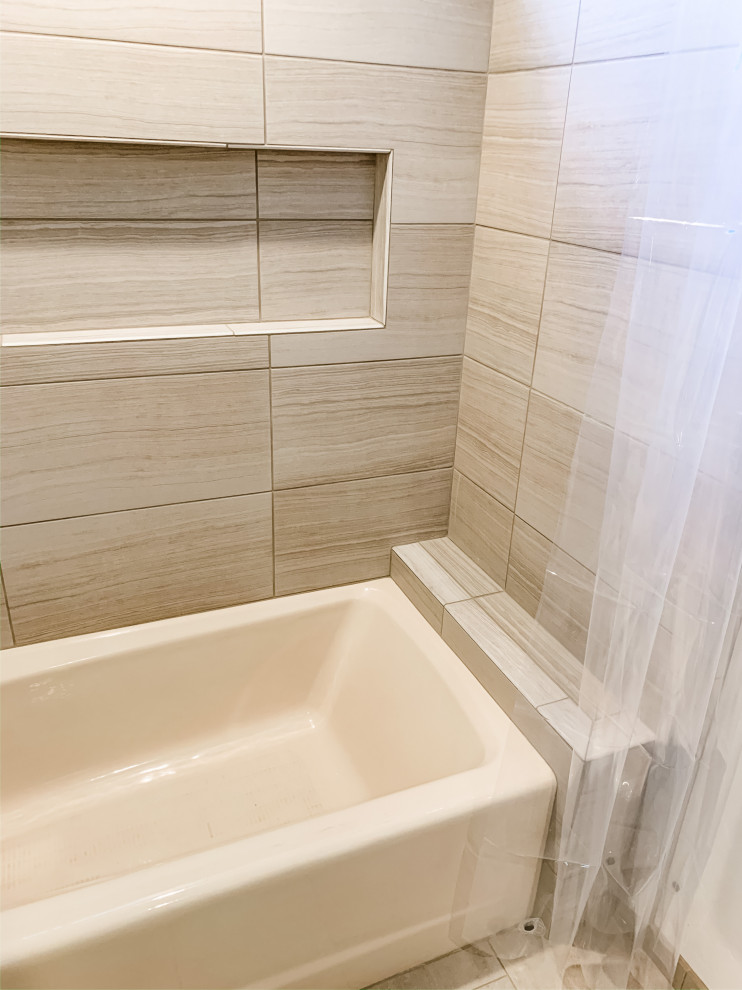 Inspiration for a small transitional bathroom in San Francisco with shaker cabinets, white cabinets, an alcove tub, an alcove shower, a one-piece toilet, beige tile, porcelain tile, white walls, porcelain floors, an undermount sink, engineered quartz benchtops, beige floor, a shower curtain and beige benchtops.