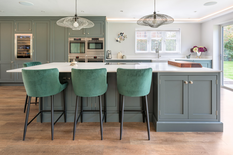 This is an example of a large transitional single-wall open plan kitchen in Sussex with with island.