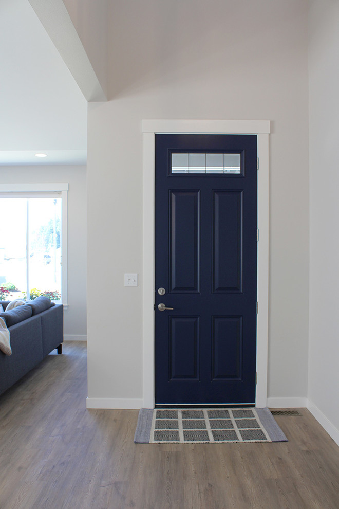 Design ideas for a mid-sized arts and crafts front door in Seattle with grey walls, vinyl floors, a single front door and a blue front door.