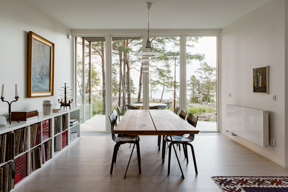 Inspiration for a mid-sized scandinavian separate dining room in Stockholm with white walls.