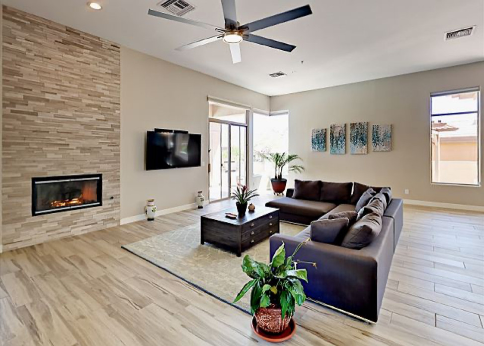 Living room - huge modern open concept porcelain tile and beige floor living room idea in Orange County with beige walls