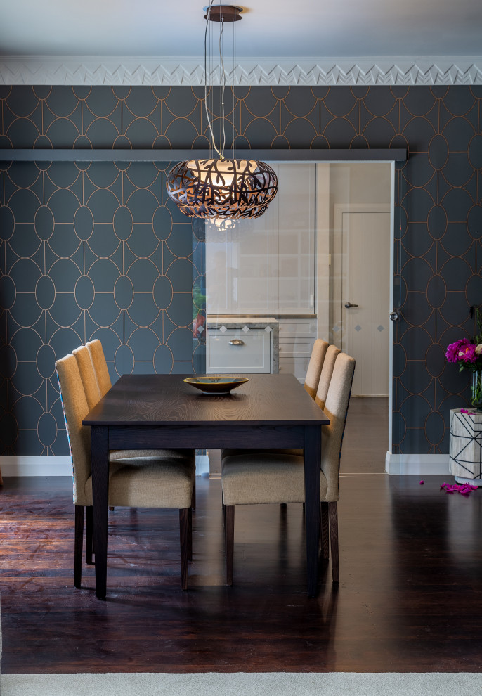 Cette photo montre une salle à manger ouverte sur la cuisine chic de taille moyenne avec un mur marron, parquet foncé, un sol marron et du papier peint.