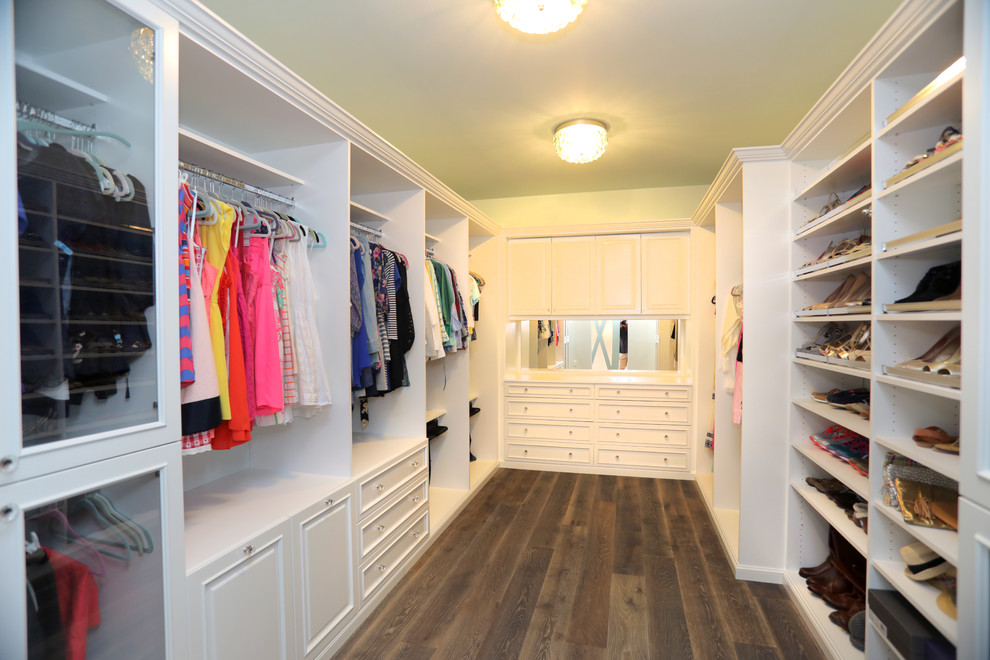 Design ideas for a large traditional gender-neutral walk-in wardrobe in Tampa with shaker cabinets, white cabinets, dark hardwood floors and brown floor.