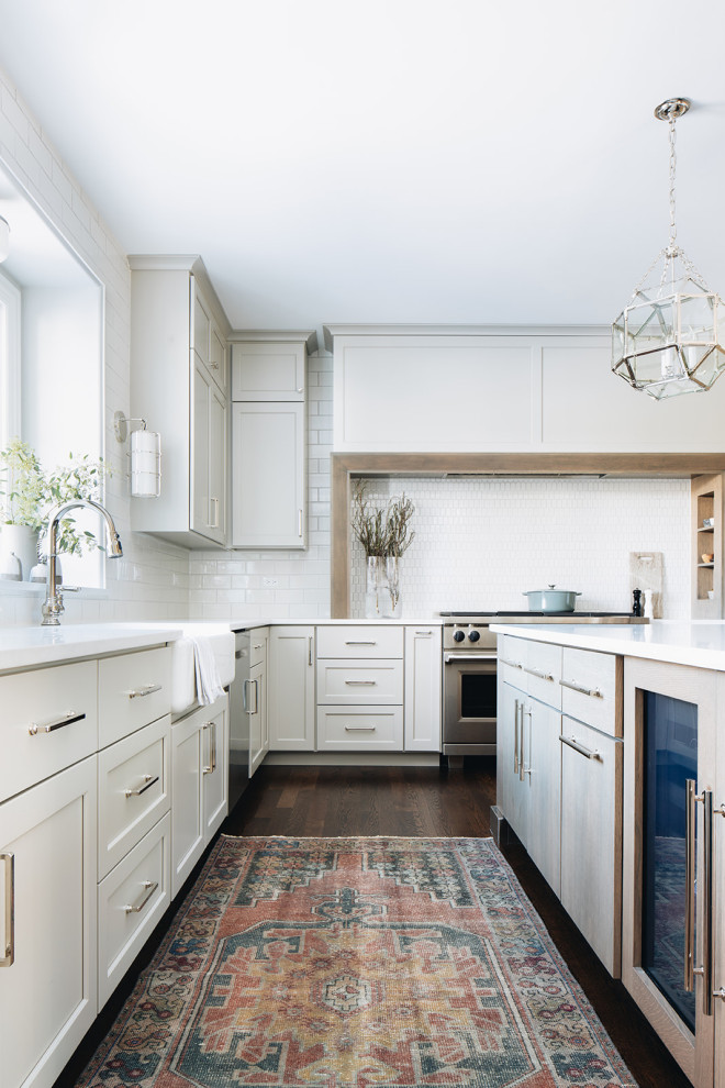 Mid-sized transitional dark wood floor eat-in kitchen photo in Chicago with a farmhouse sink, shaker cabinets, gray cabinets, quartz countertops, white backsplash, ceramic backsplash, paneled appliances, an island and white countertops
