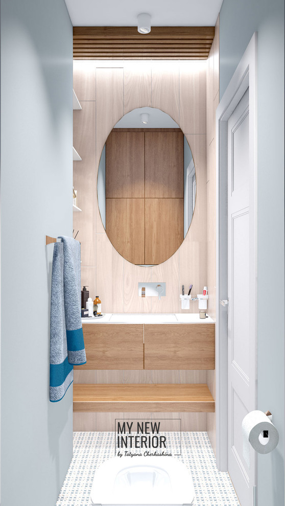 Small contemporary powder room in Saint Petersburg with flat-panel cabinets, medium wood cabinets, a wall-mount toilet, brown tile, ceramic tile, grey walls, porcelain floors, an undermount sink, solid surface benchtops, multi-coloured floor and white benchtops.