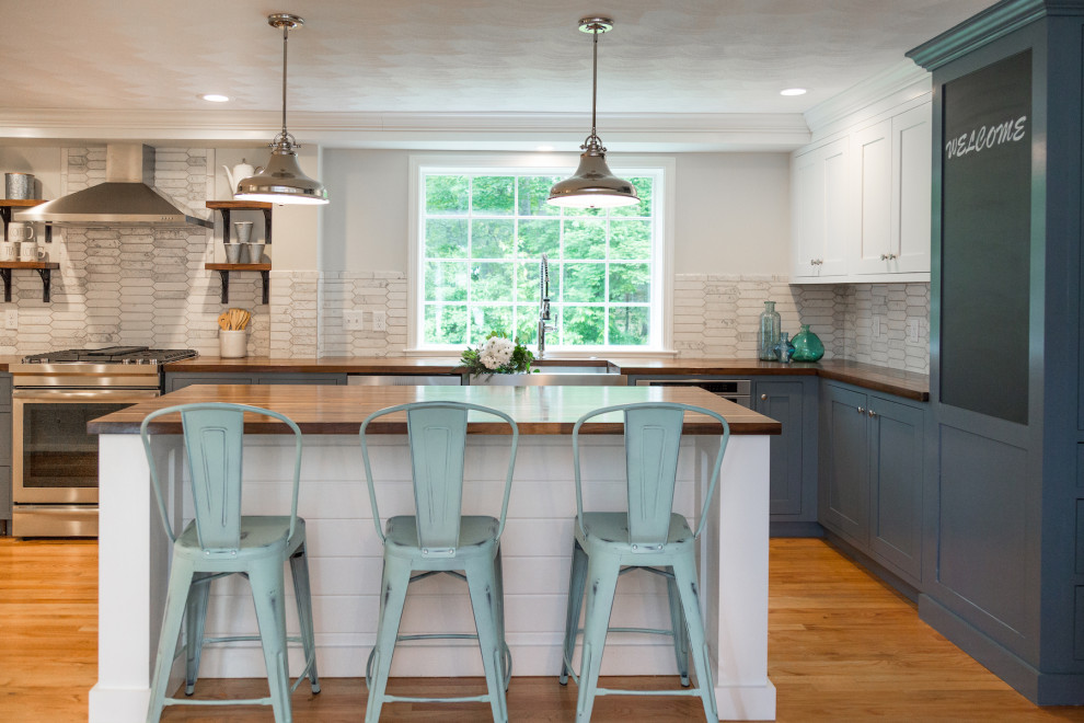 Mid-sized country l-shaped eat-in kitchen in Boston with a farmhouse sink, beaded inset cabinets, white cabinets, wood benchtops, white splashback, subway tile splashback, stainless steel appliances, medium hardwood floors, with island, brown floor and brown benchtop.