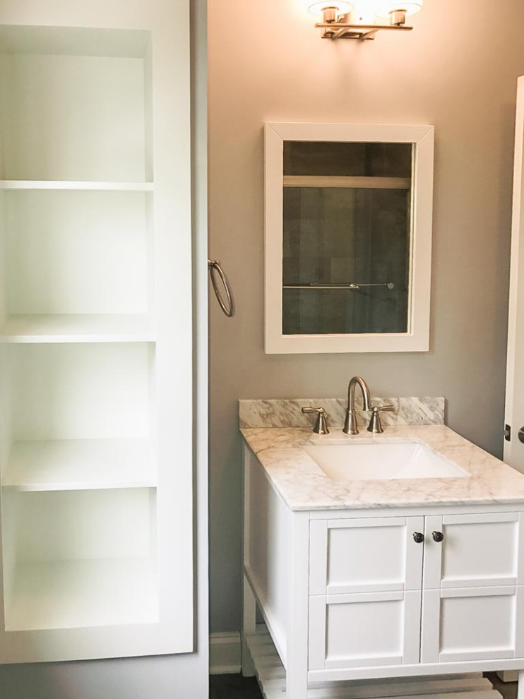 This is an example of a traditional kids bathroom in Cleveland with shaker cabinets, white cabinets, a two-piece toilet, ceramic floors, an undermount sink, marble benchtops and a freestanding vanity.