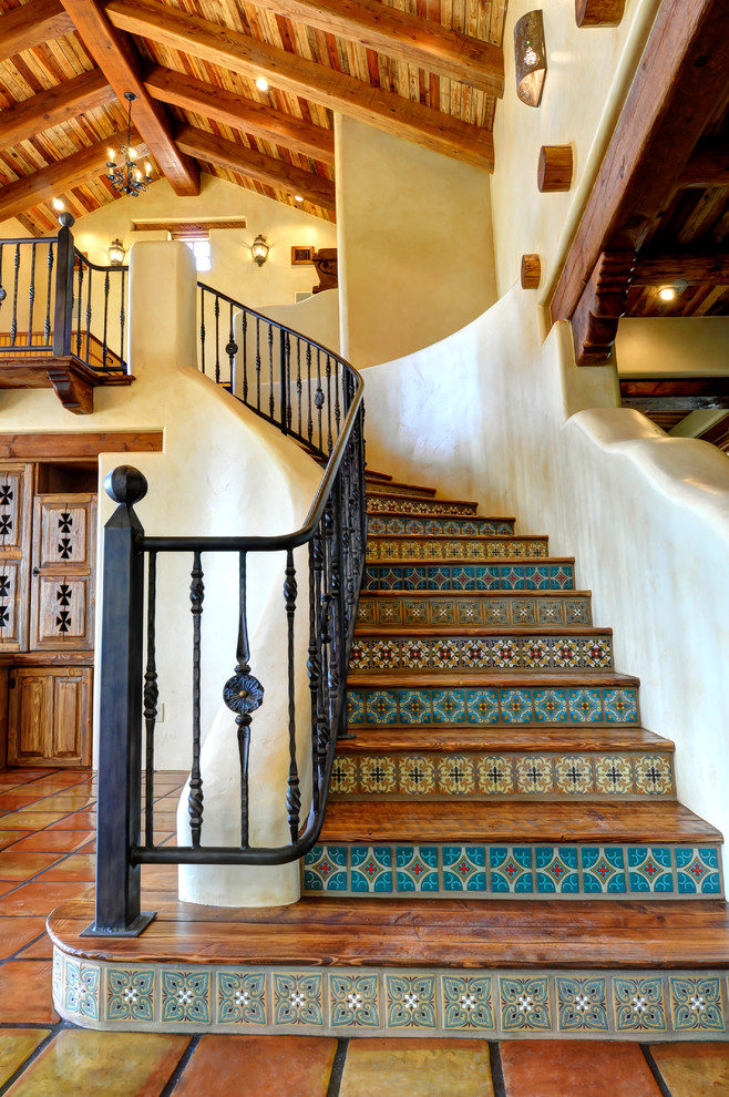 Wood curved staircase in Austin with tile risers.