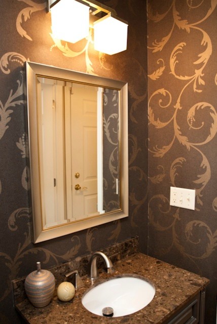 Inspiration for a small transitional bathroom remodel in Charlotte with an undermount sink, raised-panel cabinets, brown cabinets, quartz countertops and brown walls