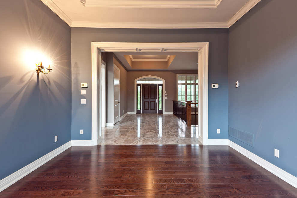 Example of a large transitional dark wood floor and brown floor front door design in Orange County with gray walls and a dark wood front door