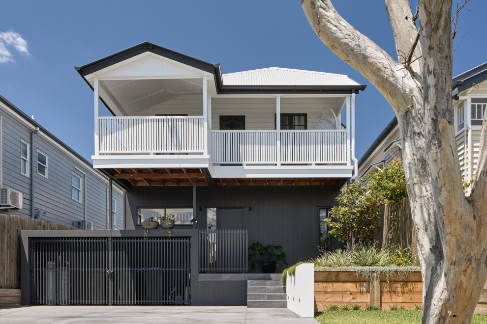 Inspiration for a contemporary white two-story metal house exterior remodel in Brisbane with a metal roof and a black roof