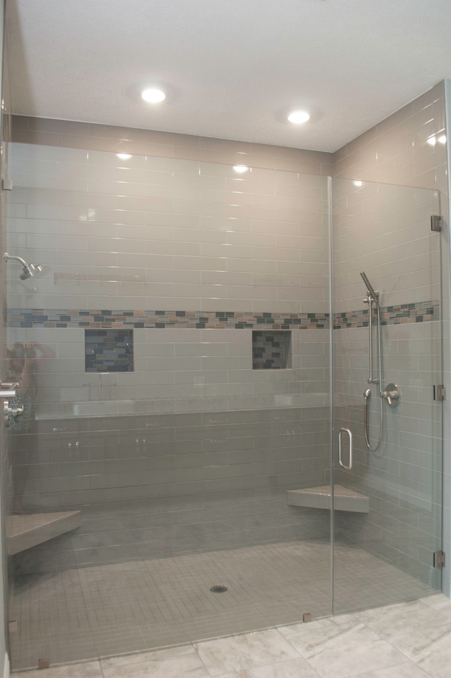 Inspiration for a large modern master bathroom in Other with shaker cabinets, grey cabinets, a freestanding tub, a double shower, a two-piece toilet, gray tile, subway tile, grey walls, porcelain floors, a vessel sink, engineered quartz benchtops, grey floor and a hinged shower door.