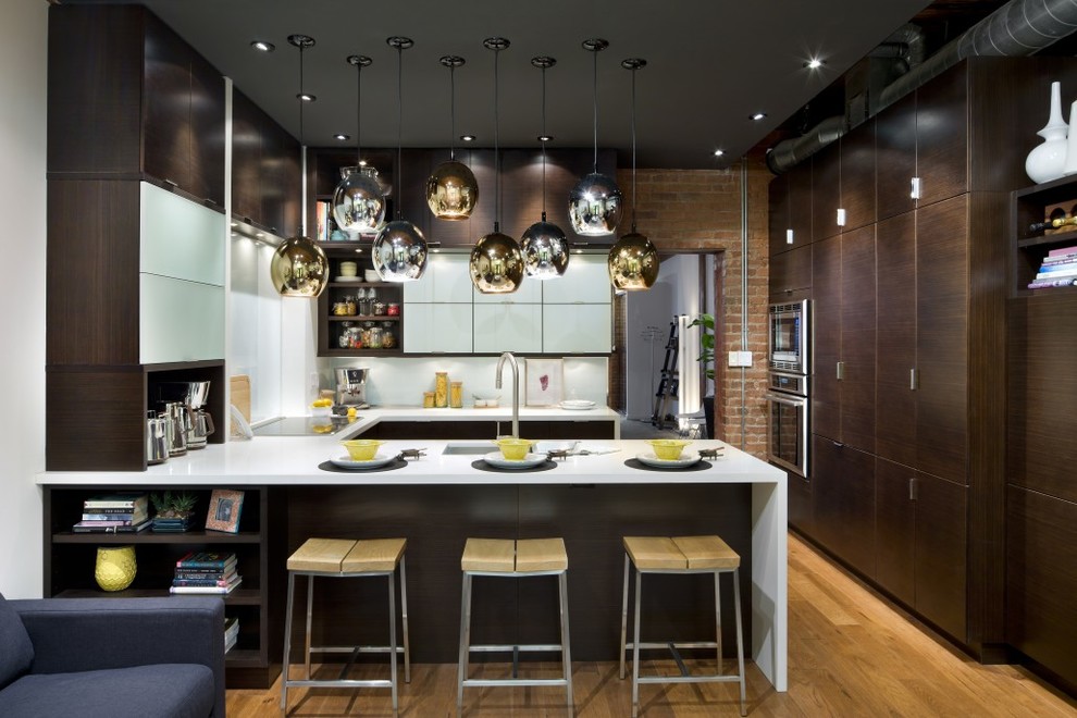 Inspiration for a mid-sized contemporary u-shaped open plan kitchen in DC Metro with an undermount sink, flat-panel cabinets, dark wood cabinets, quartz benchtops, white splashback, stone slab splashback, stainless steel appliances, light hardwood floors and a peninsula.