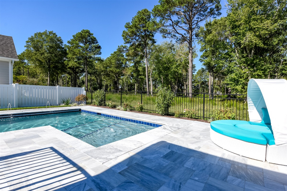 Inspiration for a mid-sized beach style backyard l-shaped pool in Other with natural stone pavers.