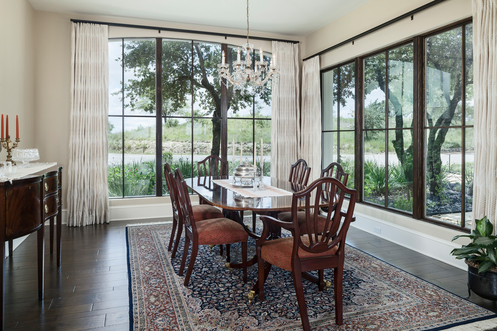 Photo of a mediterranean separate dining room in Austin with beige walls, dark hardwood floors and no fireplace.