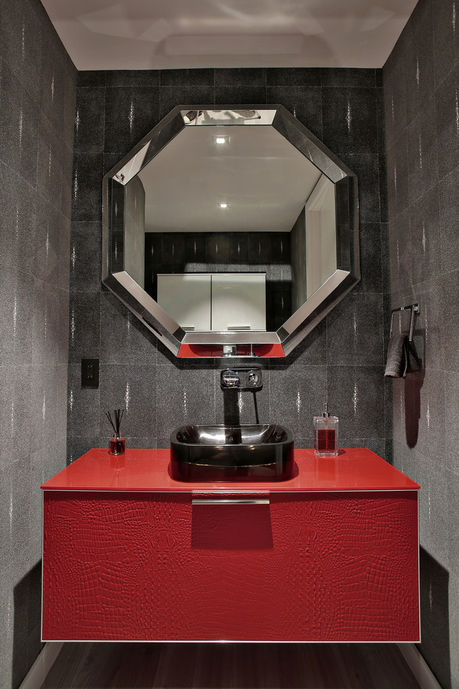 Photo of a large contemporary powder room in Miami with an undermount sink, flat-panel cabinets, red cabinets, gray tile, grey walls and porcelain floors.