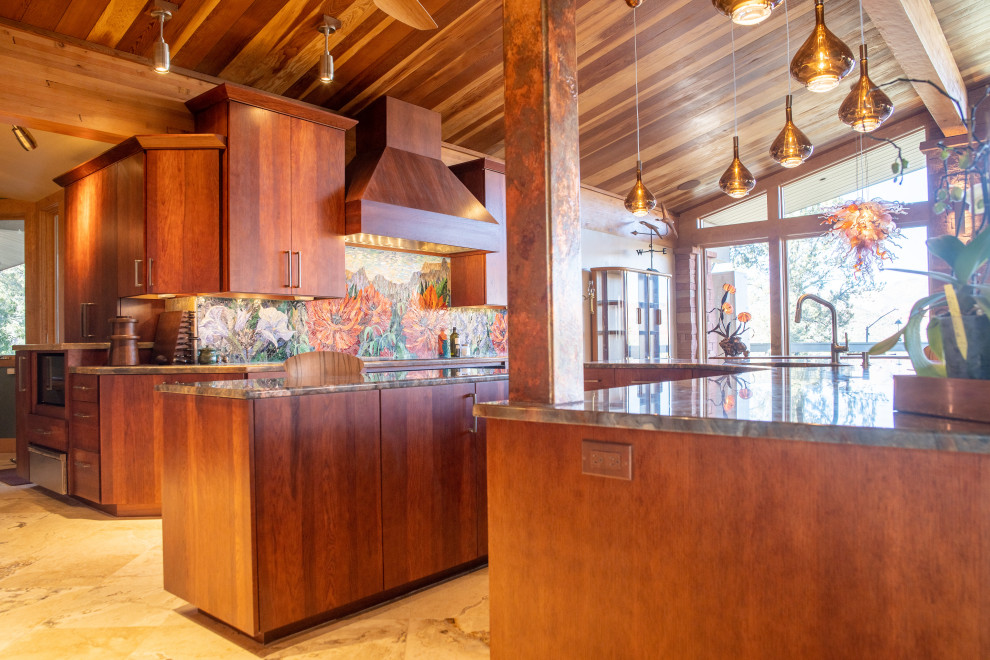 Eclectic kitchen photo in Phoenix with flat-panel cabinets, red cabinets, granite countertops, glass tile backsplash, paneled appliances and an island