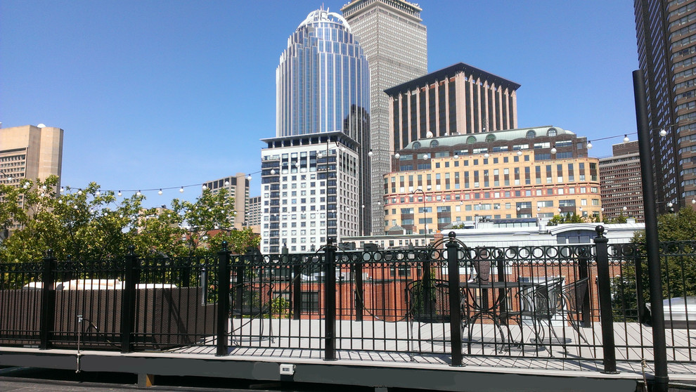Expansive transitional rooftop deck in Boston with no cover.
