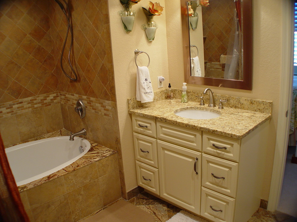Photo of a mid-sized traditional 3/4 bathroom in Miami with raised-panel cabinets, white cabinets, an alcove tub, a shower/bathtub combo, beige tile, ceramic tile, beige walls, ceramic floors, an undermount sink, granite benchtops, beige floor and a shower curtain.