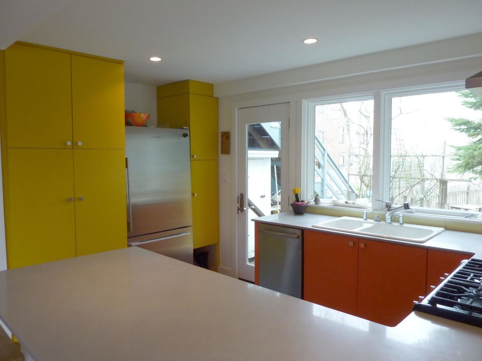 Inspiration for a small contemporary u-shaped kitchen remodel with a double-bowl sink and flat-panel cabinets