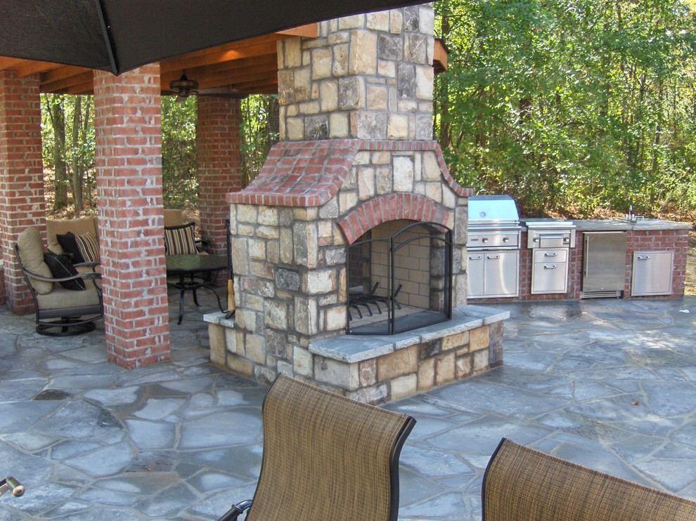 Design ideas for a large traditional backyard patio in Atlanta with a fire feature, natural stone pavers and a gazebo/cabana.
