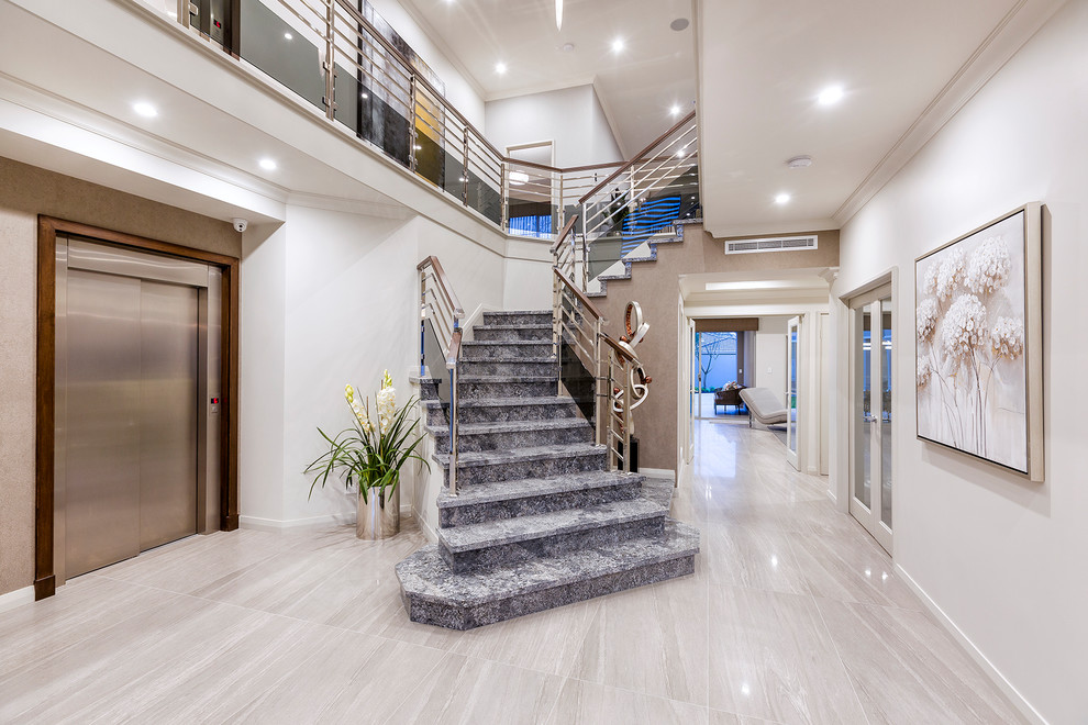 Design ideas for a large contemporary marble l-shaped staircase in Perth with marble risers and mixed railing.
