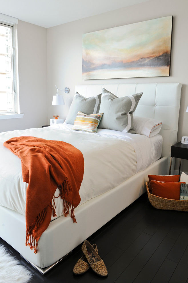 Contemporary bedroom in Vancouver with beige walls, dark hardwood floors, no fireplace and black floor.