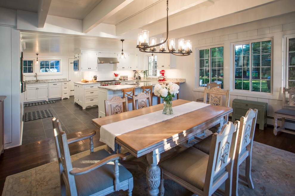 Example of a mid-sized transitional u-shaped ceramic tile and gray floor eat-in kitchen design with white walls, no fireplace, an undermount sink, recessed-panel cabinets, white cabinets, granite countertops, white backsplash, wood backsplash, stainless steel appliances, a peninsula and multicolored countertops