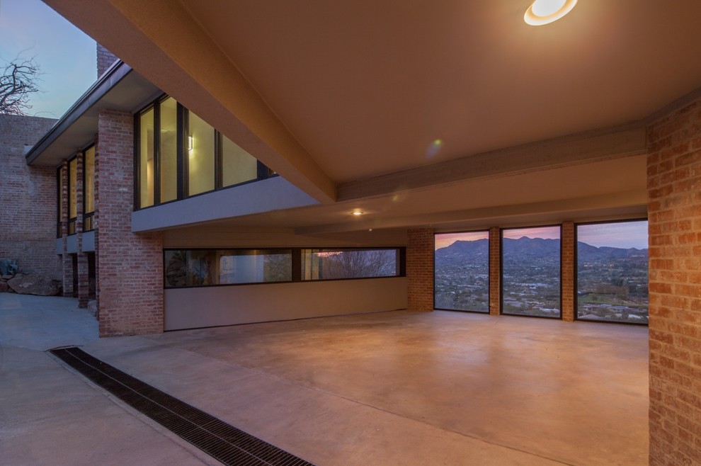 Photo of a large contemporary attached three-car garage in Phoenix.