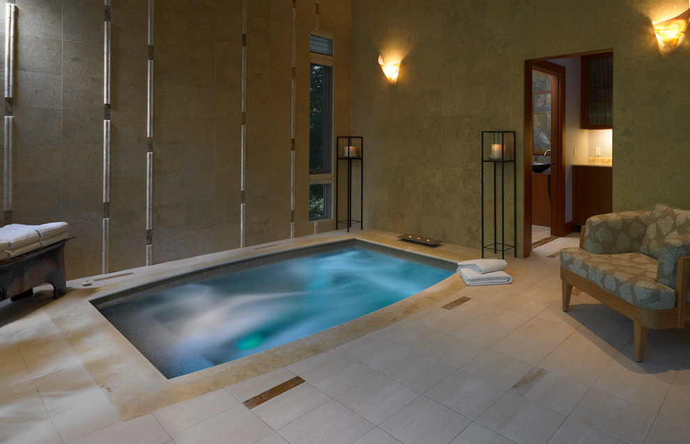 Transitional indoor rectangular pool in Boston with a hot tub.