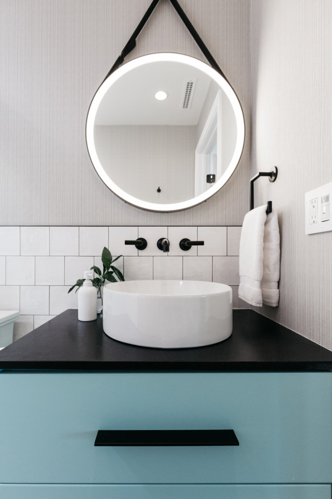 Small contemporary 3/4 bathroom in Los Angeles with flat-panel cabinets, turquoise cabinets, an alcove shower, a two-piece toilet, white tile, porcelain tile, white walls, vinyl floors, a vessel sink, granite benchtops, a sliding shower screen, black benchtops, a niche, a single vanity, a floating vanity and wallpaper.