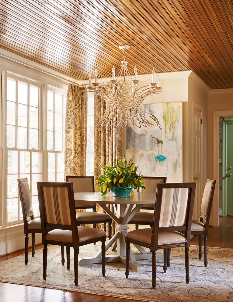 This is an example of a mid-sized traditional dining room in Charlotte with beige walls and medium hardwood floors.