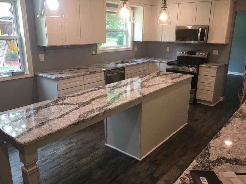 Example of a mid-sized transitional galley gray floor eat-in kitchen design in Detroit with white cabinets, stainless steel appliances and an island