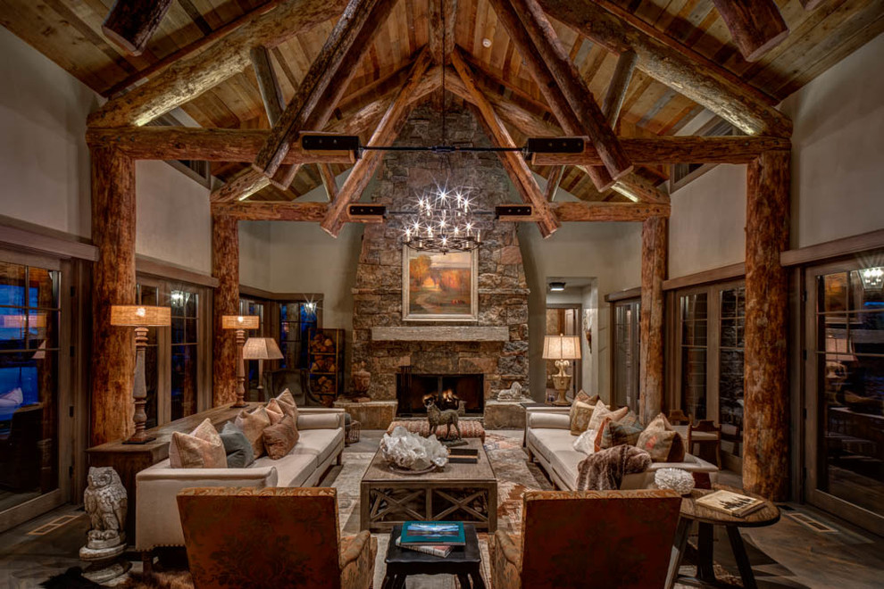This is an example of a large country open concept family room in Salt Lake City with white walls, a standard fireplace, a stone fireplace surround, no tv, dark hardwood floors and brown floor.