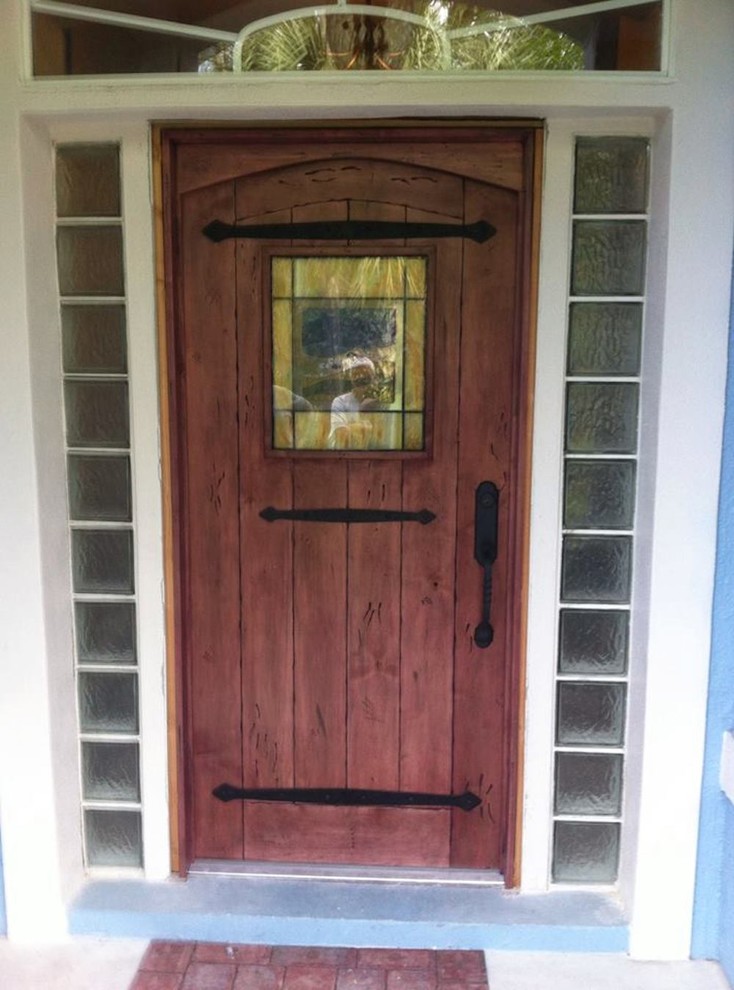Inspiration for a small front door in Orlando with a single front door and a medium wood front door.