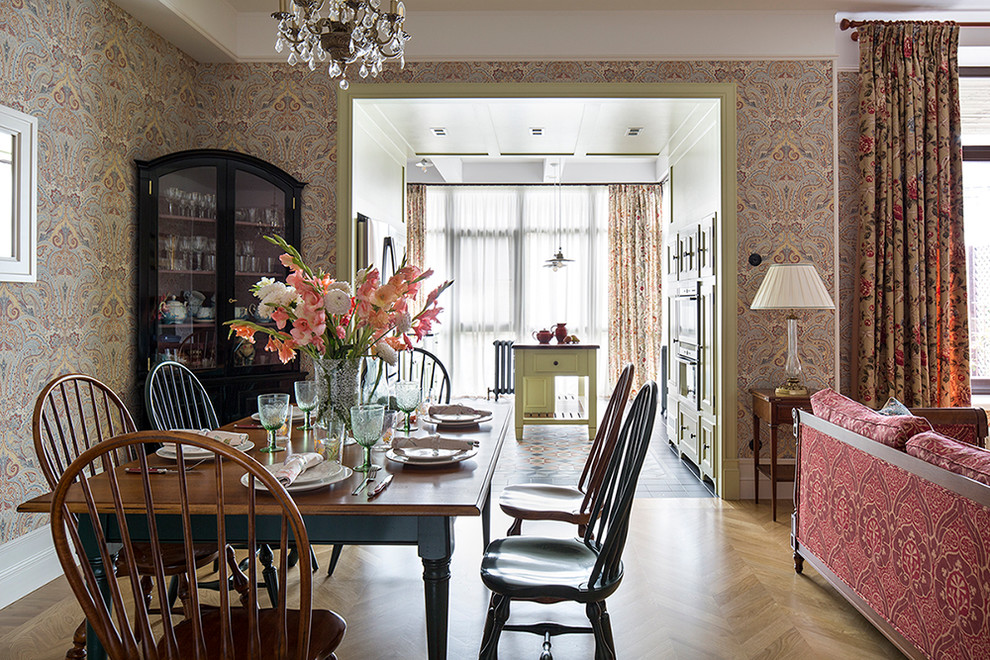 Mid-sized traditional open plan dining in Moscow with multi-coloured walls and light hardwood floors.
