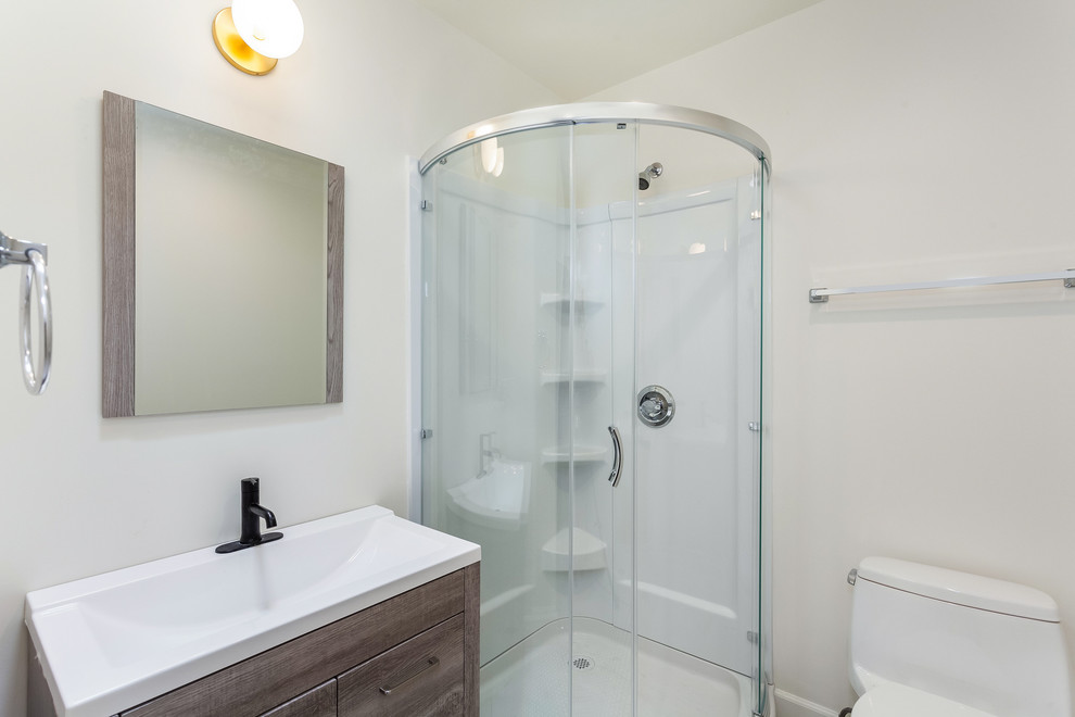 Small contemporary 3/4 bathroom in Los Angeles with flat-panel cabinets, distressed cabinets, a corner shower, a one-piece toilet, white tile, white walls, porcelain floors, a vessel sink, engineered quartz benchtops, black floor and a sliding shower screen.
